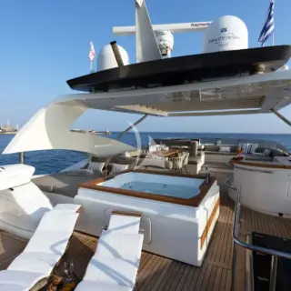 The exceptionally spacious Fly Bridge has a large Jacuzzi, hard top with electrically retractable canvas roof, a bar, a large foldable dining table, lounges & sunbathing areas