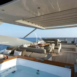 The exceptionally spacious Fly Bridge has a large Jacuzzi, hard top with electrically retractable canvas roof, a bar, a large foldable dining table, lounges & sunbathing areas