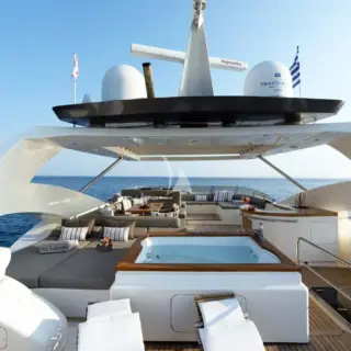 The exceptionally spacious Fly Bridge has a large Jacuzzi, hard top with electrically retractable canvas roof, a bar, a large foldable dining table, lounges & sunbathing areas