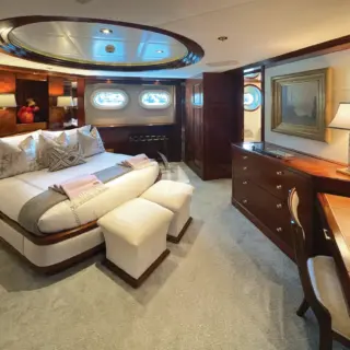 Perceptive of guest Queen stateroom with luxurious textiles, cozy lighting and comfortable seating
