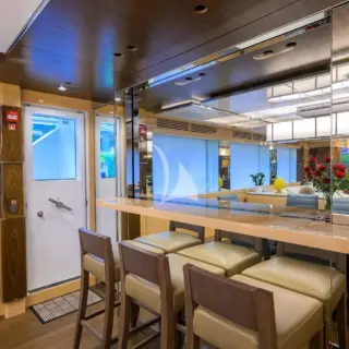 TROPA - Main Salon bar seating- with a window that opens to see the galley