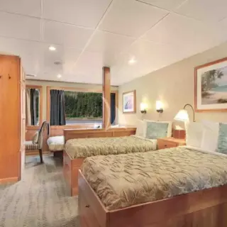 'Admiral Cabin'. B1, C1-C2. Cabin and Main Deck. King or twin beds; windowed door or view windows; private bath with Jacuzzi tub and shower. Triple accommodation available in C1 and C2.