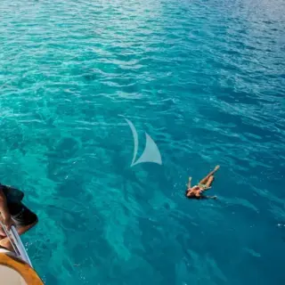 Swimming in aquamarine waters off the Yacht