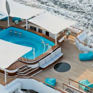 Expansive sundeck with 2-level pool and bar to relax in the sun